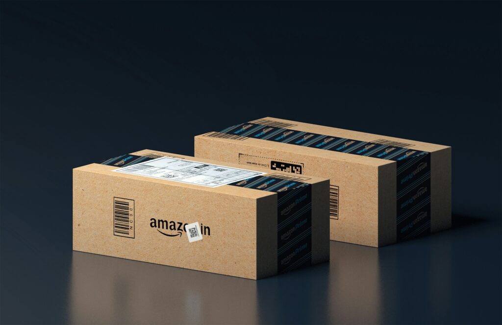 Two Amazon Prime delivery boxes on a dark surface, representing how to shop on Amazon from Nigeria using virtual USD cards like Swyftpay.