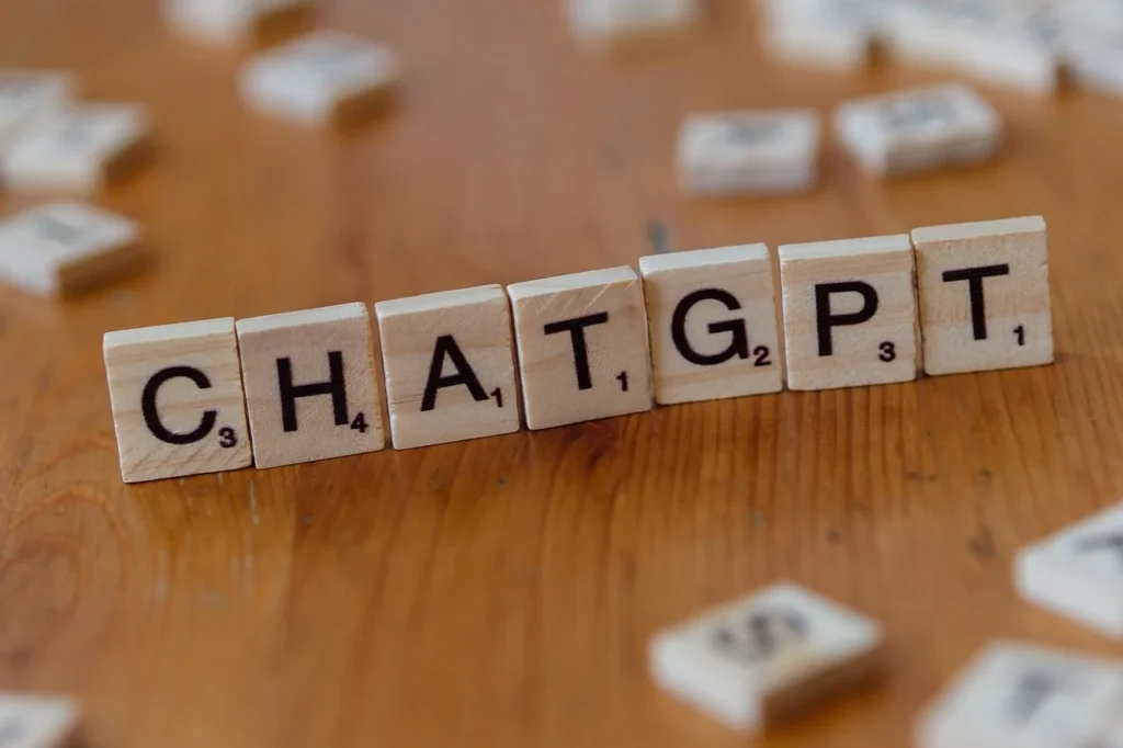 Scrabble tiles spelling "CHATGPT" on a table, showing how to pay for ChatGPT Plus in Nigeria.